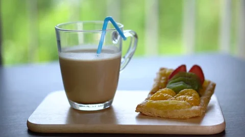 Putting Straw into Cup of Iced Coffee Stock Footage 105782546