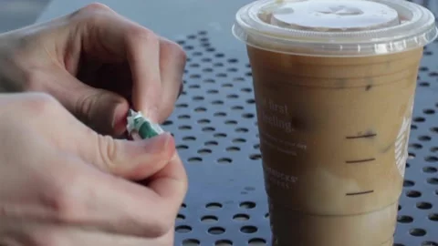 Putting Straw Into Iced Coffee Stock Footage 134739280