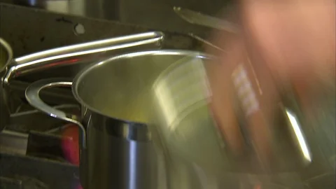 Putting stripped carrots on a pot Stock Footage 86222146