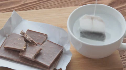 Putting sugar and tea bag in a glass mug with hot water Stock Footage 68974283