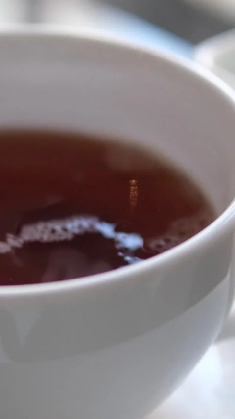 Putting Sugar in to Black Coffee. dark cane sugar Falling Down Into Coffee Cup Stock Footage 302079747