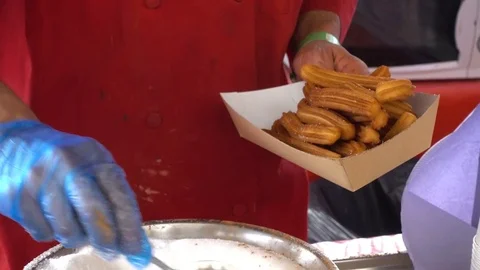 Putting sugar on the churros- close up Video stock 78230106