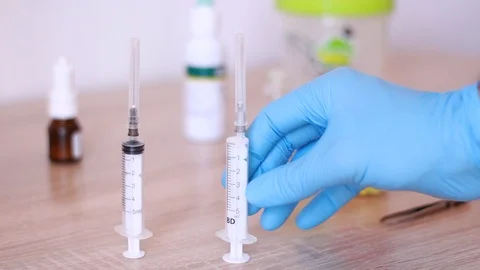 Putting syringes vertically on table Stock Footage 96239982