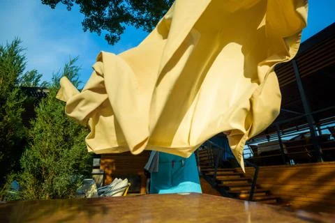 Putting tablecloth on table 스톡 사진