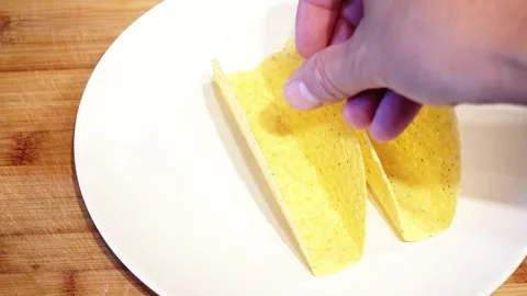Putting Taco Shells On Plate For Mexican Food Stock Footage 246869432