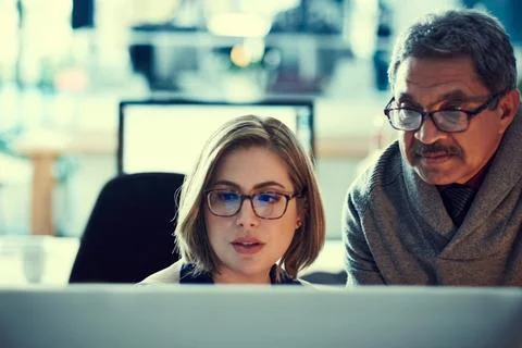 Putting their minds together to transform business. two businesspeople working Stock Photos
