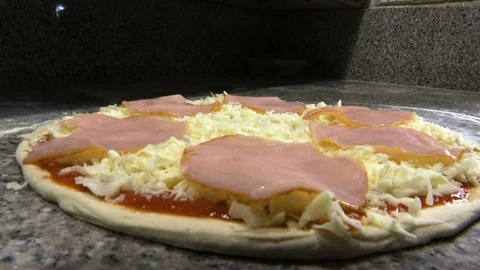 Putting thinly sliced bacon on pizza Stock Footage 123649832