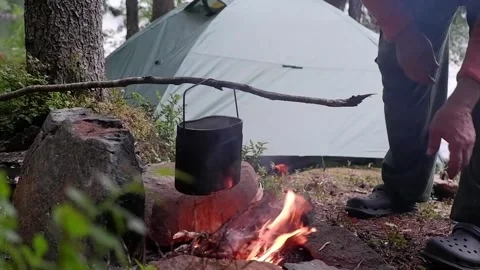 Putting tin can on fire while camping in the forest Stock Footage 223330893