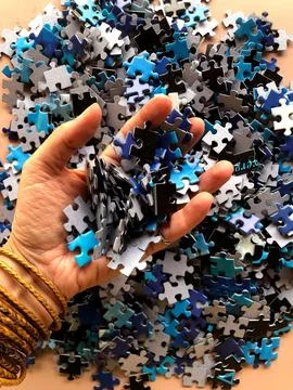Putting together a puzzle Stock Photos