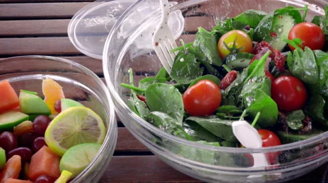 Putting Tomato on Salad Stock Footage 64231903