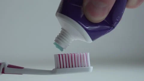 Putting toothbrush paste on toothbrush, close up Stock Footage 130905587