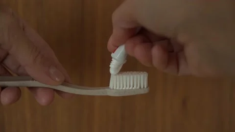 Putting toothpaste on the brush Stock Footage 132688485
