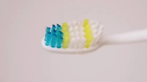 Putting toothpaste on brush slow motion close  Stock Footage 73431144