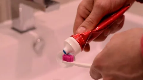Putting toothpaste on toothbrush. Stock Footage 48922767
