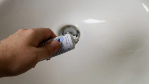 Putting toothpaste on a toothbrush Video stock 101593371
