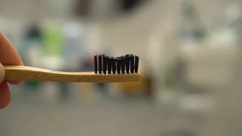 Putting toothpaste onto toothbrush Stock Footage 131434570