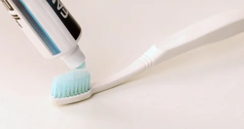 Putting tootpaste on a toothbrush Stock Footage 97260468