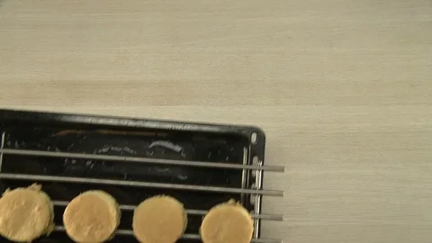 Putting of tray with cake moulds on the table Stock Footage 77907264