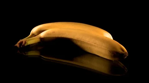 Putting two bananas on a table Stock Footage 8841430