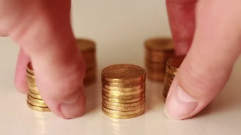 Putting two columns of golden coins 스톡 동영상 73506902