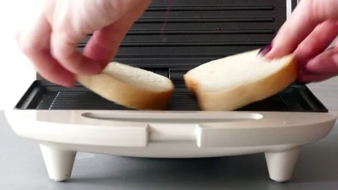 Putting two slices of bread in a toaster Stock Footage 72559516