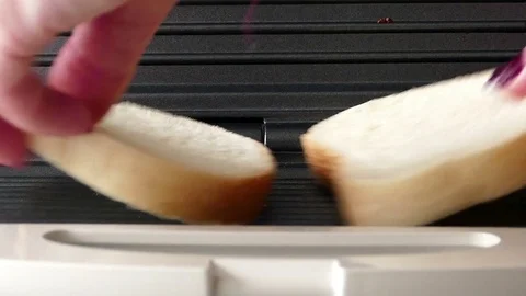 Putting two slices of bread in a toaster Stock Footage 72757051