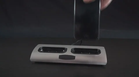 Putting Two Smartphones Into A Dock Front-Shot Stock-Footage 35770012