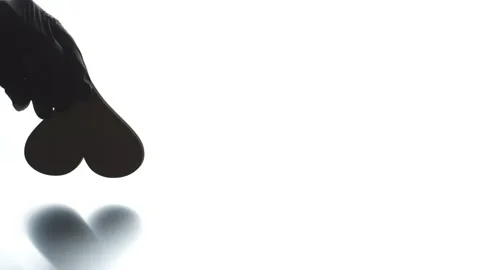 Putting upside down heart symbol black icon on light background. Hatred concept Stock Footage 143846413