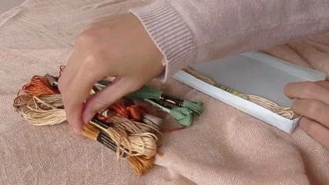 Putting a variety of threads on a little box Stock Footage 146248700