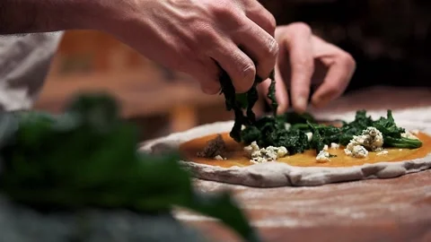 Putting vegetables onto the pizza Stock Footage 136375676