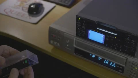 Putting video tape (compact VHS) into adapter and watching footage. Видео 151132677