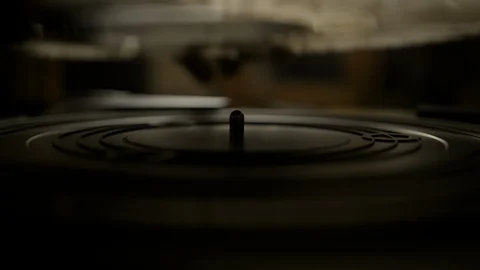 Putting vinyl record on turntable and putting stylus needle on Stock Footage 129573276