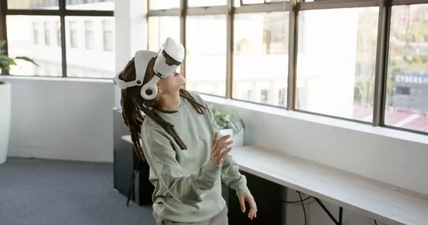 Putting on VR headset, African American nonbinary exploring office VR demo, Stock Footage 344693566