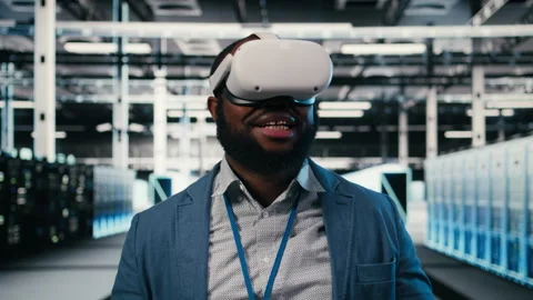 Putting on VR headset, network management and employee in server farm Stock Footage 330030343