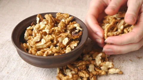 Putting Walnut Kernels Into Ceramic Bowl Stock Footage 65774272