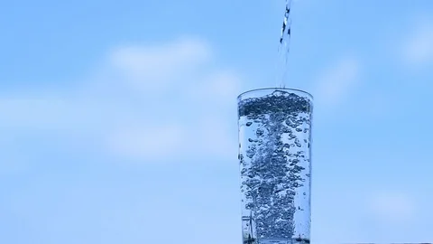 Putting water into the glass until full Stock Footage 106942669