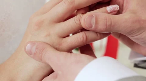 Putting wedding ring on bride finger Stock Footage 58264487