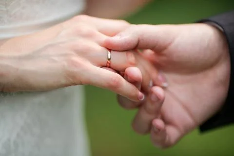 Putting on a wedding ring Stock Photos