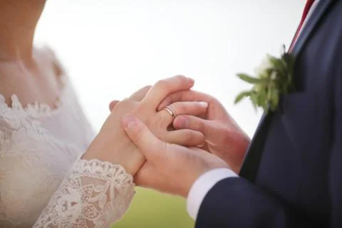 Putting on a wedding ring Stock Photos