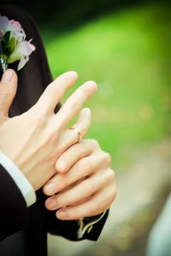 Putting on wedding ring Stock Photos