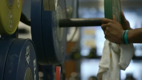 Putting weights on a barbell Stock Footage 103867739