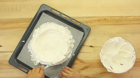 Putting whipped cream on a cake A cherry Pavlova cake perfect for summer Stock Footage 68386730