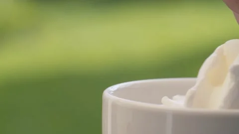 Putting whipping cream into a cup Stock Footage 137646593