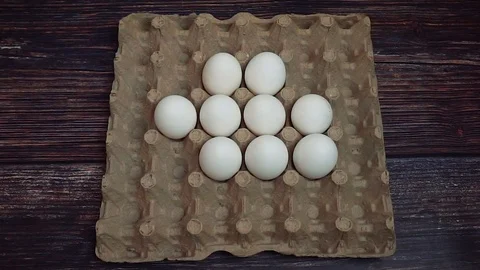 Putting white chickhen eggs in a box Stock-Footage 107816400