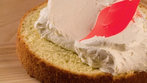 Putting white Cream inside Sweet Cake cooking video Stock Footage 102621011