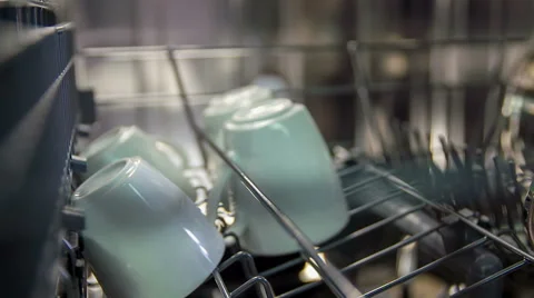 Putting white cups on a rack in the dishwasher Stock Footage 61852620
