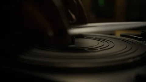 Putting a white vinyl record on turntable and putting stylus needle on Video stock 129587733