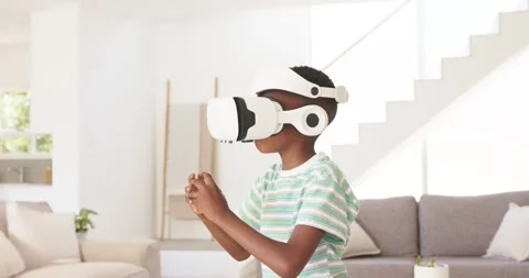 Putting on white VR headset, African child selecting, reaching, grabbing VR Stock Footage 337026234