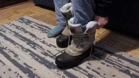 Putting on Winter Boots Stock Footage 328744018