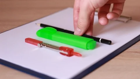 Putting writing accessories on folder of paper Stock Footage 86231035